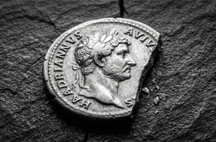 Fragmented ancient Roman coin on stone