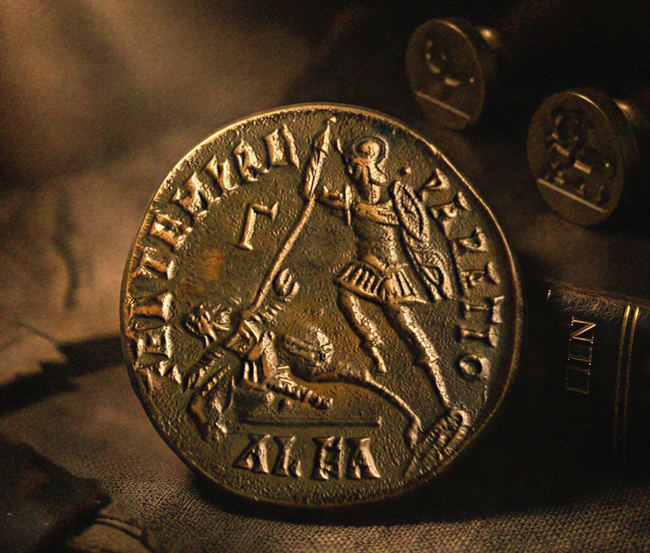 Ancient coin depicting a warrior and a fallen horseman